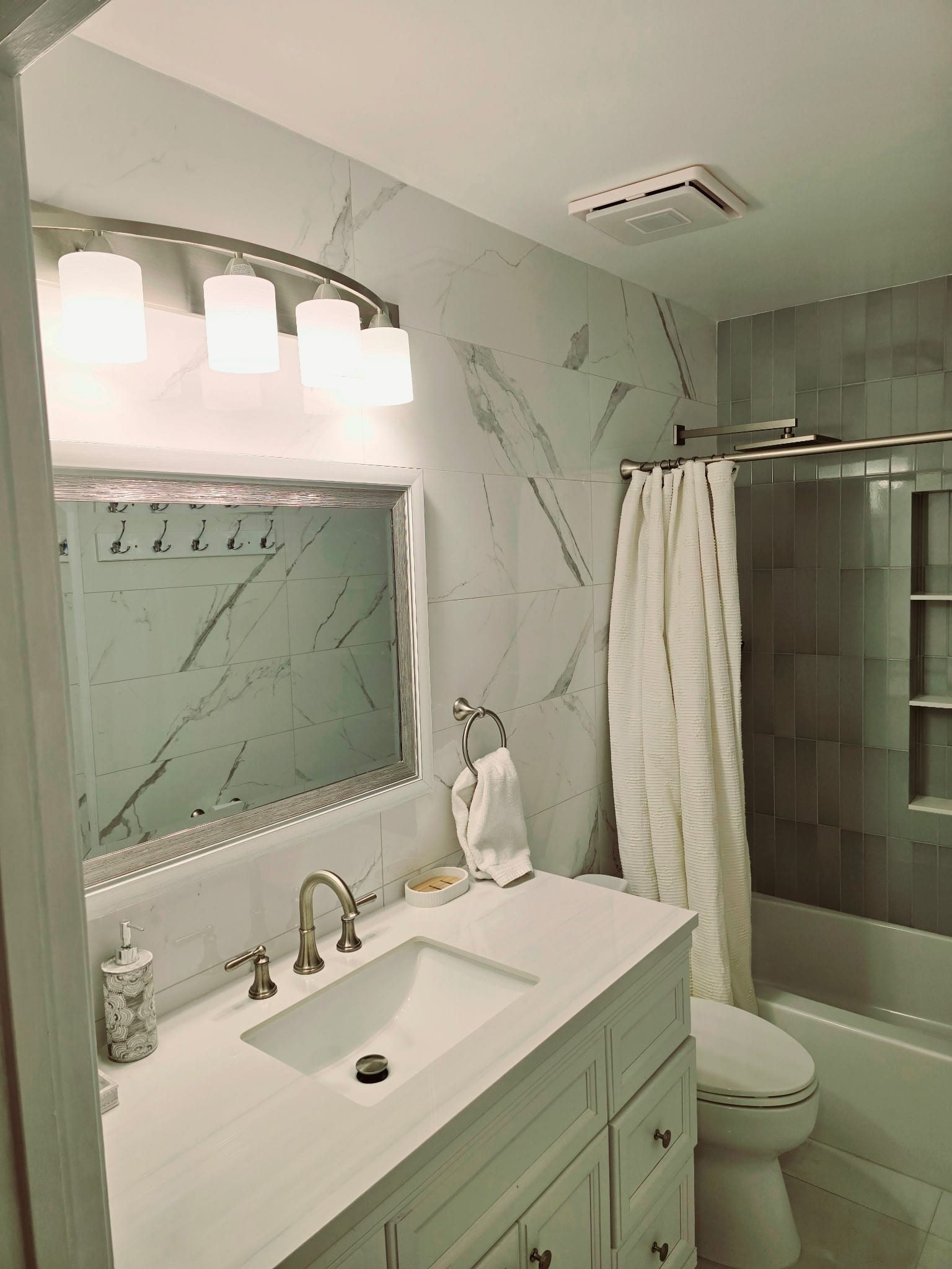 Compact Calacatta bath — vanity view